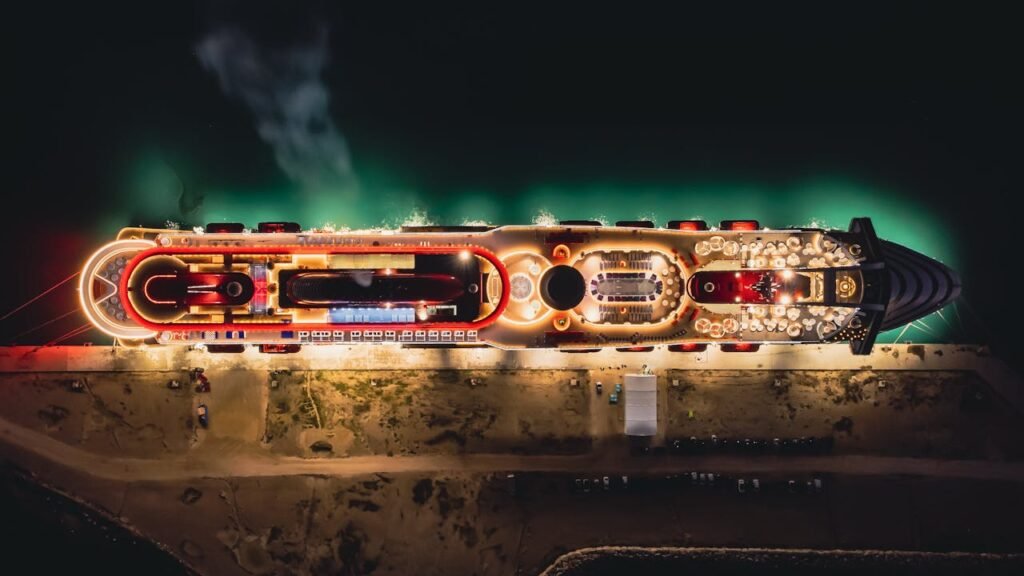 Stunning aerial night view of a luxury cruise ship moored in Civitavecchia, Italy.
