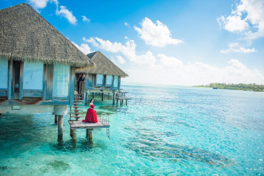 Idyllic Maldives overwater bungalows with turquoise lagoon and a couple enjoying paradise.